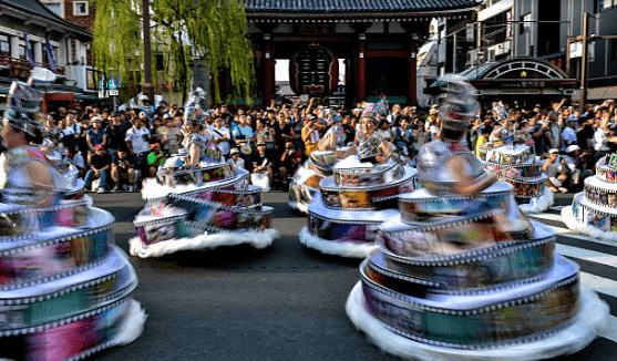 Feathered samba dancers and a float parading down Umamichi-dori at the Asakusa Samba Carnival